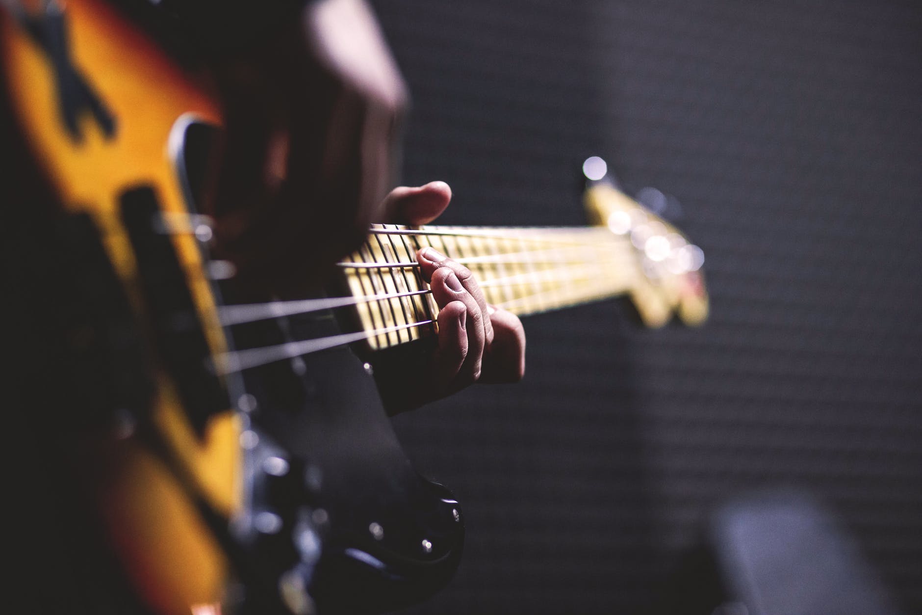 Photo by freestocks.org on <a href="https://www.pexels.com/photo/person-playing-sun-burst-electric-bass-guitar-in-bokeh-photography-96380/" rel="nofollow">Pexels.com</a>