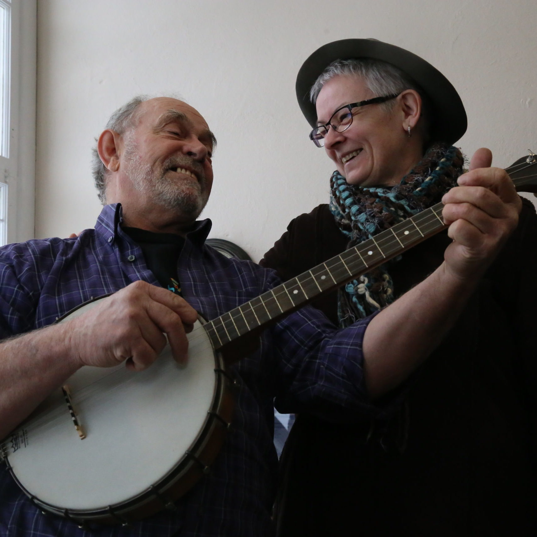 Two people jamming with a banjo
